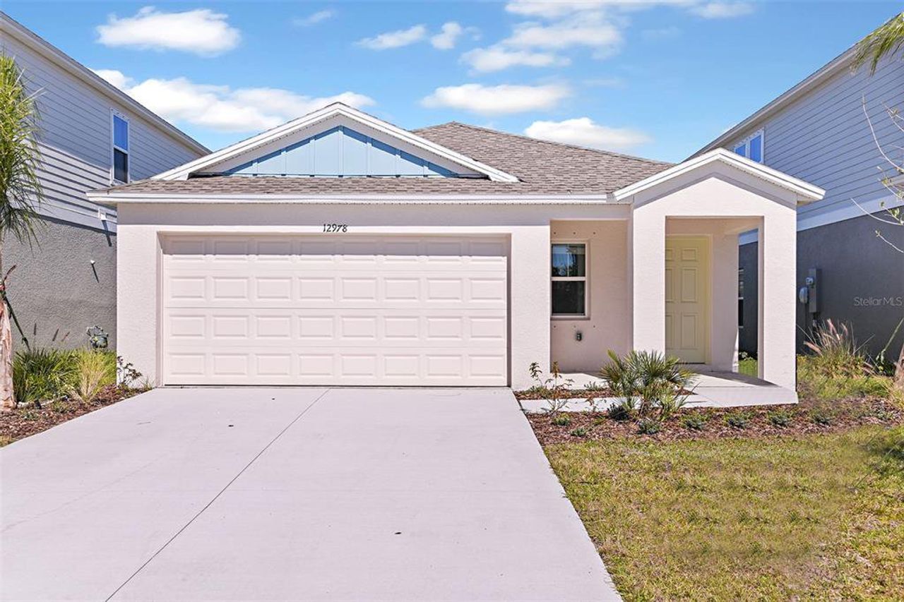 Front exterior of a new home in Villa Mar, Winter Haven, FL, highlighting curb appeal (Image 2).