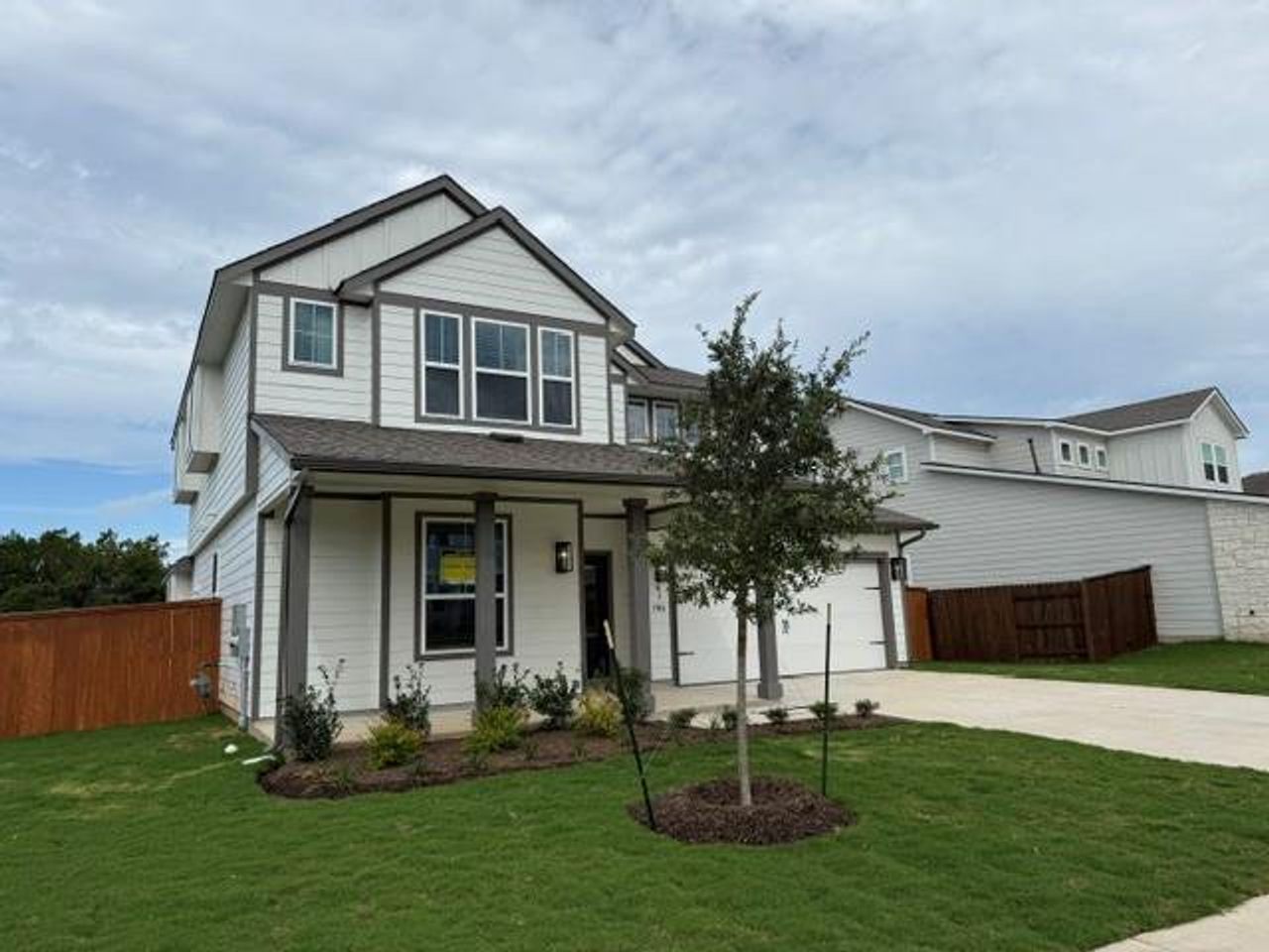 Modern two-story residence with a pristine lawn and attached garage. Modern two-story residence with a pristine lawn and attached garage.