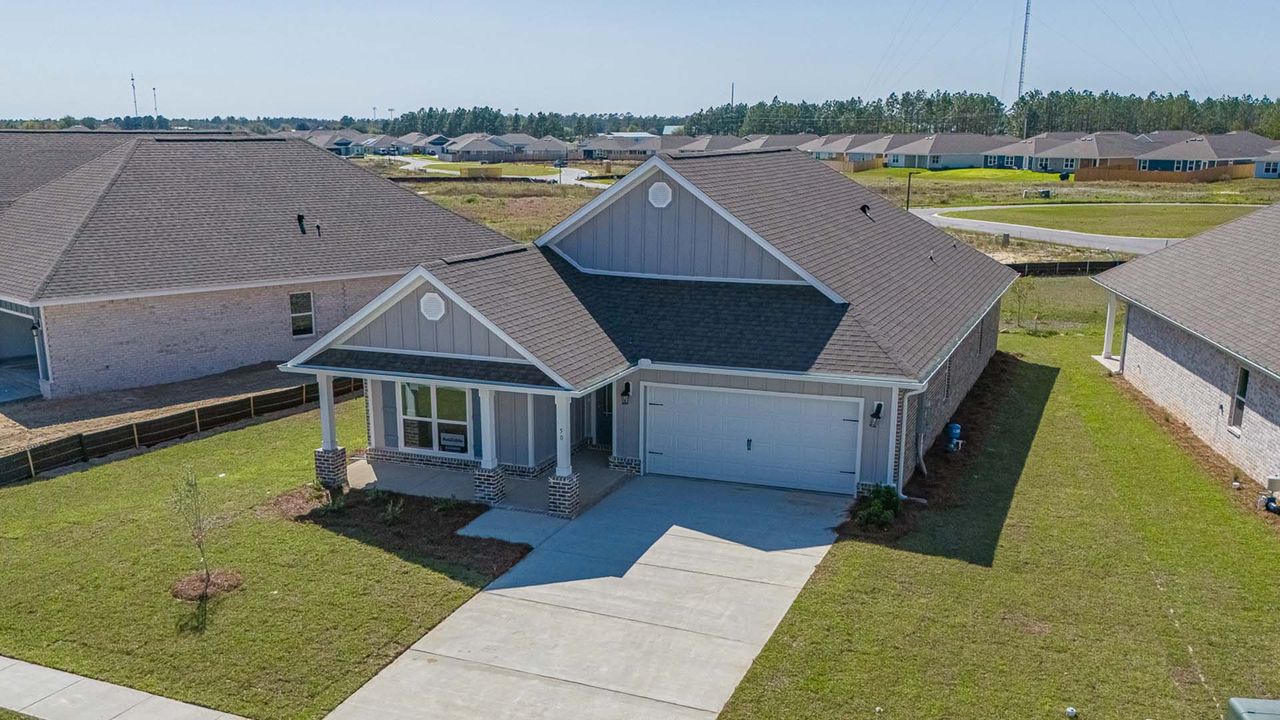 Front exterior of a new home in Owl's Head Farms, Freeport, FL, highlighting curb appeal (Image 2).