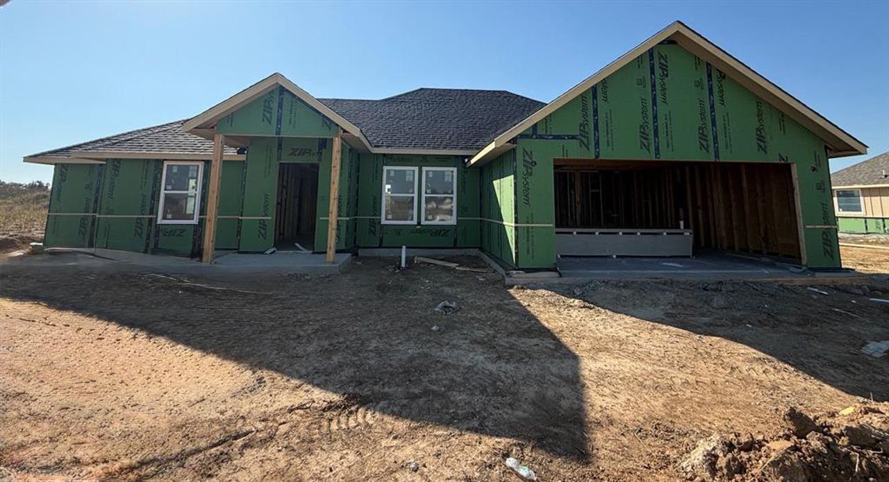Property in mid-construction with roof with shingles