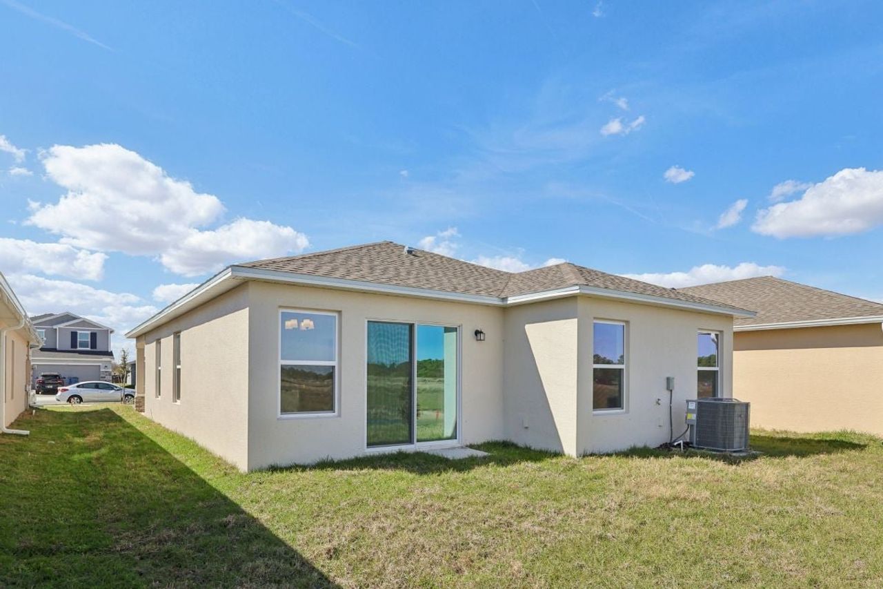 Exterior details and patio area of a home in Gardens at Waterstone I, Palm Bay (Image 2).