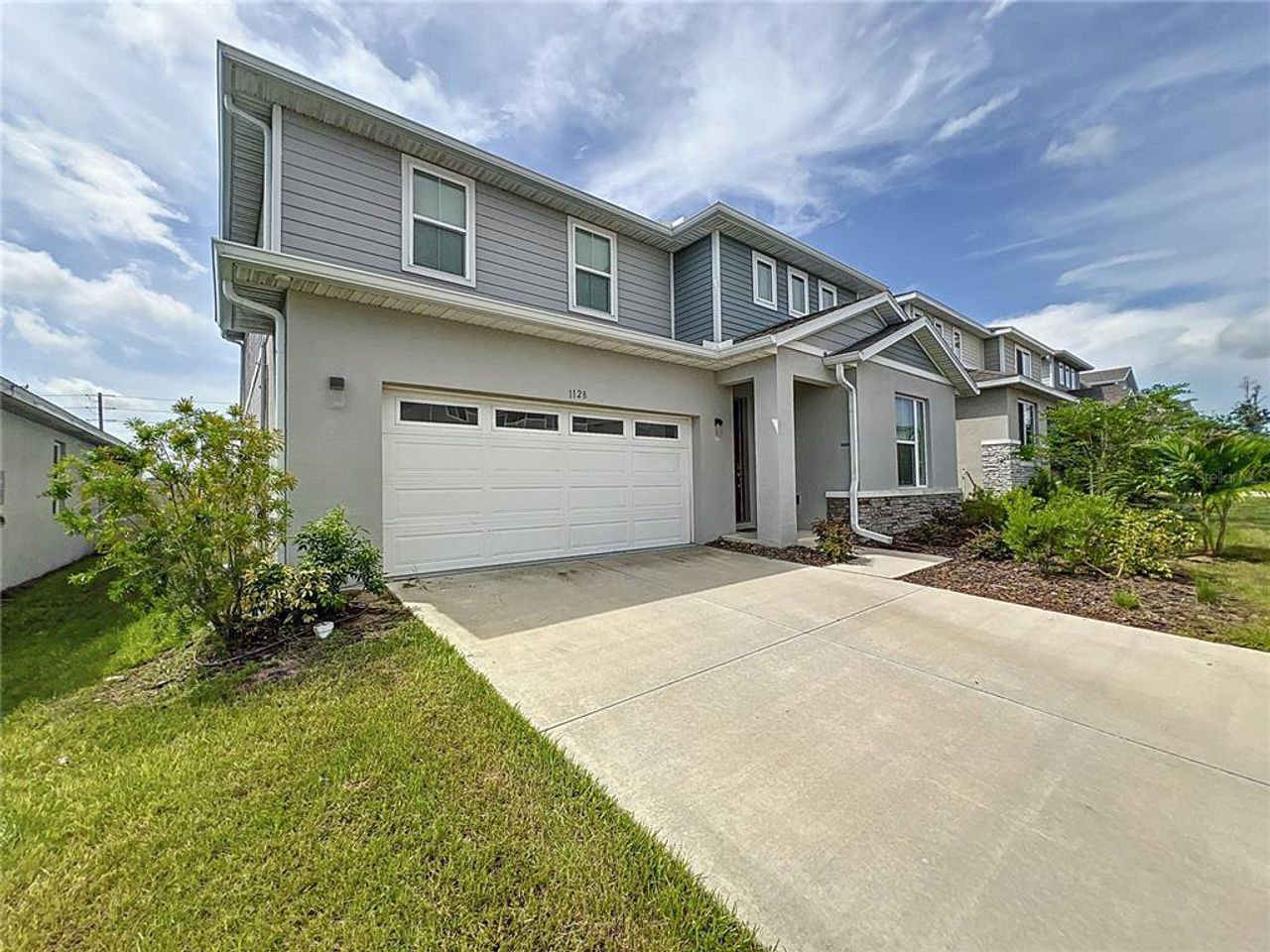 Front exterior of a new home in Seasons at Forest Lake, Davenport, FL, highlighting curb appeal (Image 2). Front exterior of a new home in Seasons at Forest Lake, Davenport, FL, highlighting curb appeal (Image 2).