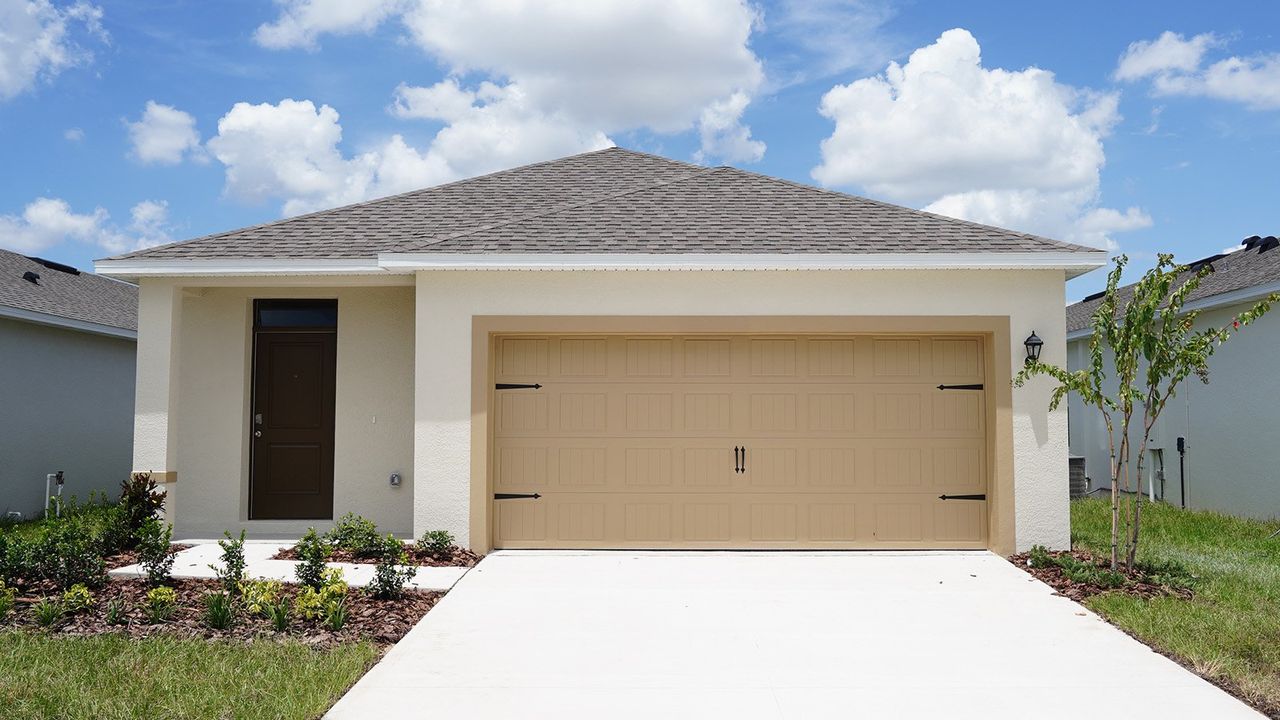 Front exterior of a new home in Magnolia Pointe, Umatilla, FL, highlighting curb appeal (Image 2).