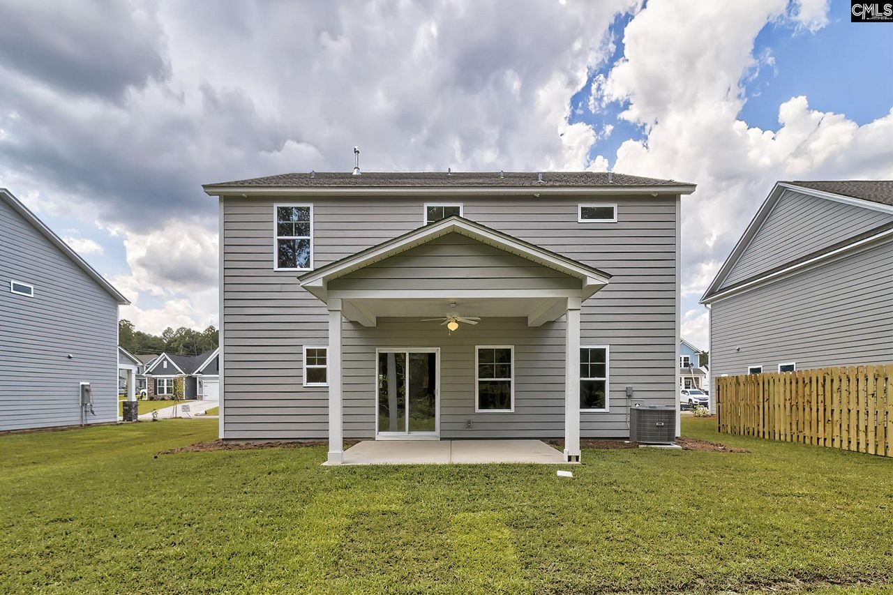 Exterior details and patio area of a home in Cottages at Roofs Pond, West Columbia (Image 2).
