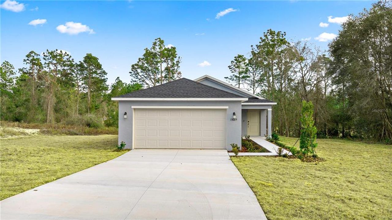 Front exterior of a new home in Marion Ranch, Ocala, FL, highlighting curb appeal (Image 2).