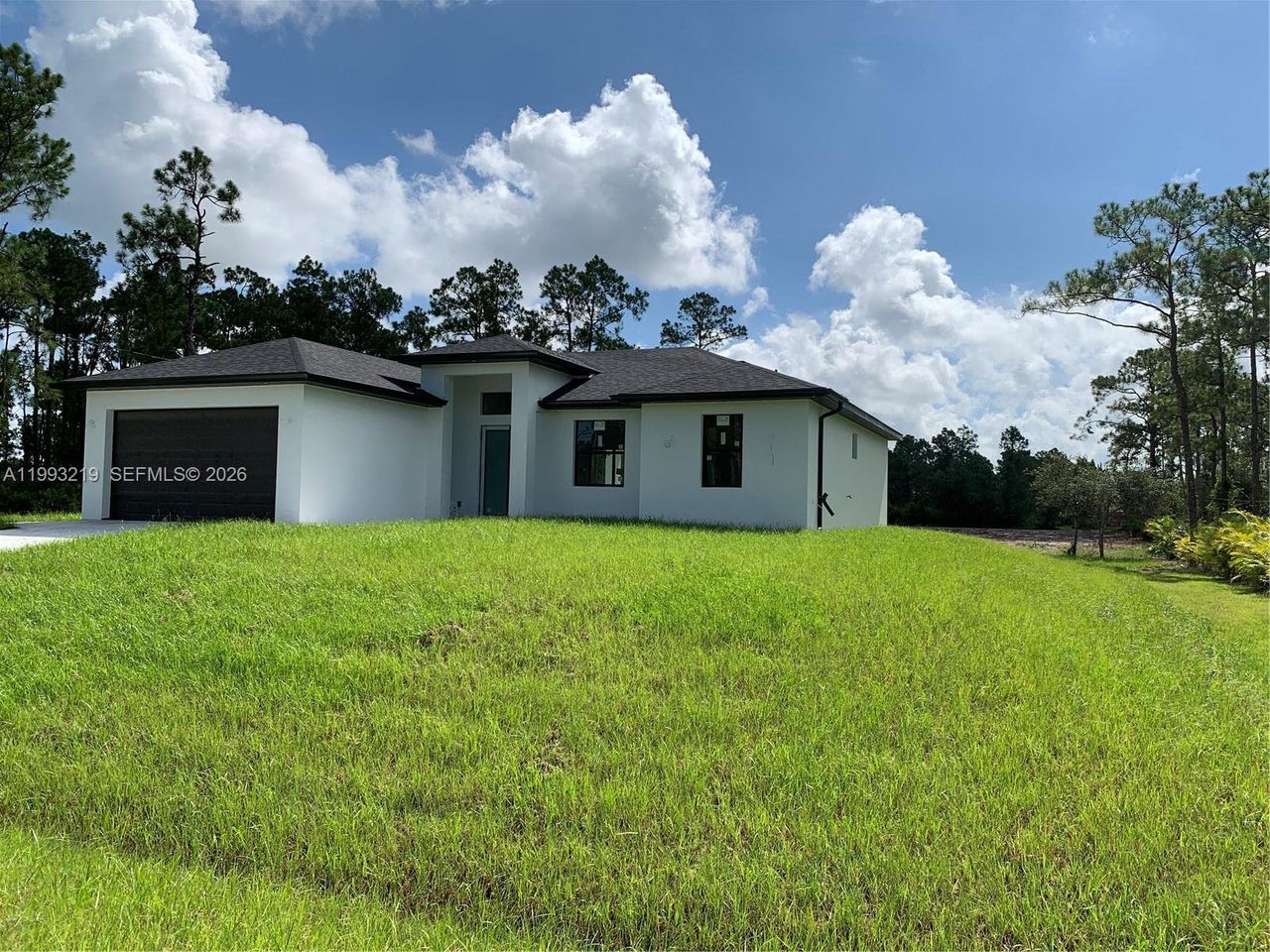 Front exterior of a new home in , Lehigh Acres, FL, highlighting curb appeal (Image 2). Front exterior of a new home in , Lehigh Acres, FL, highlighting curb appeal (Image 2).