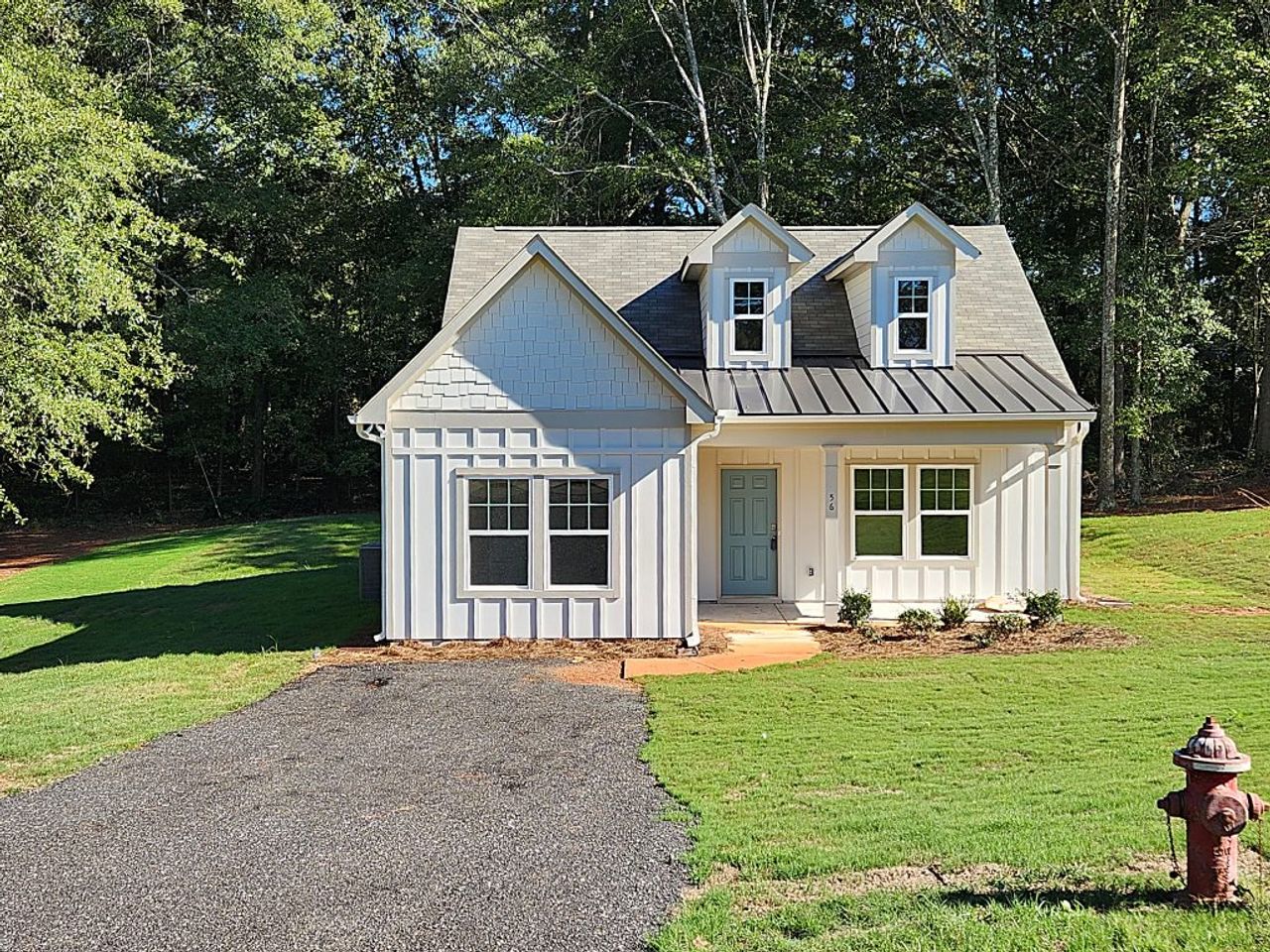 Front exterior of a new home in Clemit Harris Place, Newnan, GA, highlighting curb appeal (Image 2). Front exterior of a new home in Clemit Harris Place, Newnan, GA, highlighting curb appeal (Image 2).
