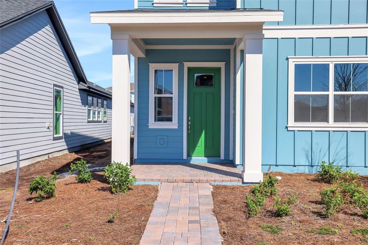 Front exterior of a new home in Weslyn Park at Sunbridge (Craft Homes), St. Cloud, FL, highlighting curb appeal (Image 2).