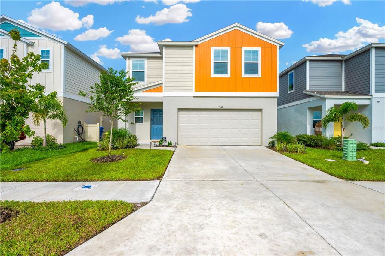 Front exterior of a new home in Pasadena Point, Wesley Chapel, FL, highlighting curb appeal (Image 2). Front exterior of a new home in Pasadena Point, Wesley Chapel, FL, highlighting curb appeal (Image 2).