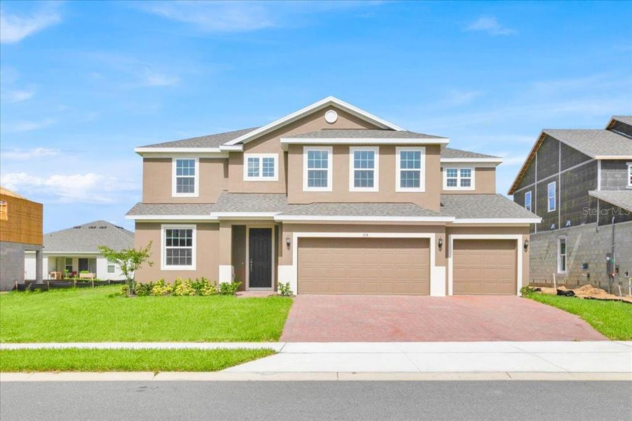 Front exterior of a new home in Park View at the Hills, Clermont, FL, highlighting curb appeal (Image 2).