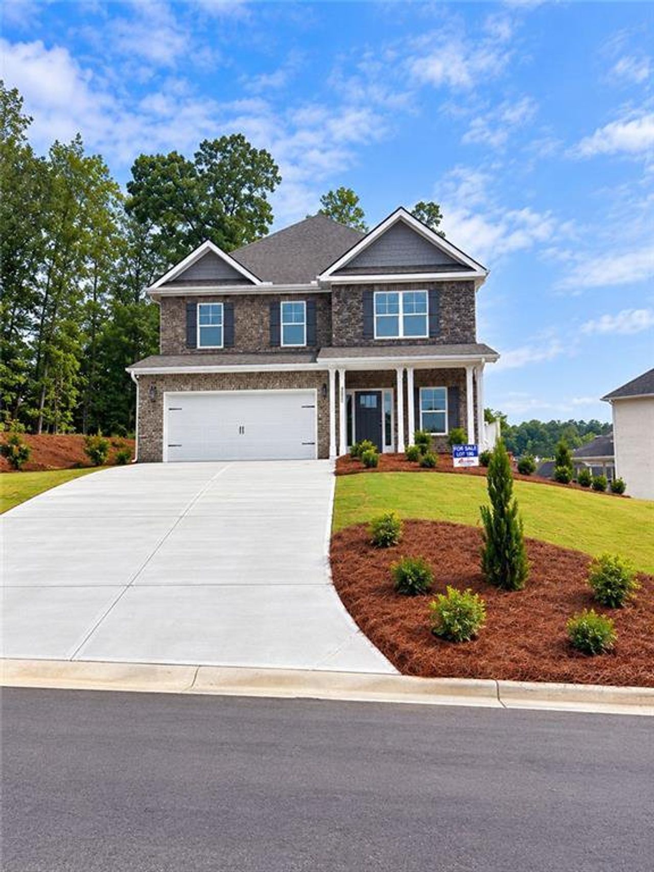 Front exterior of a new home in Mirror Lake at South Harbour, Villa Rica, GA, highlighting curb appeal (Image 2).