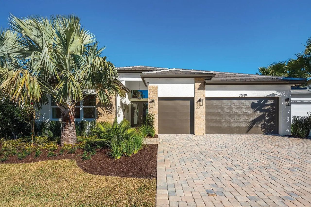 Front exterior of a new home in Valencia Ridge (55+), Wesley Chapel, FL, highlighting curb appeal (Image 2).