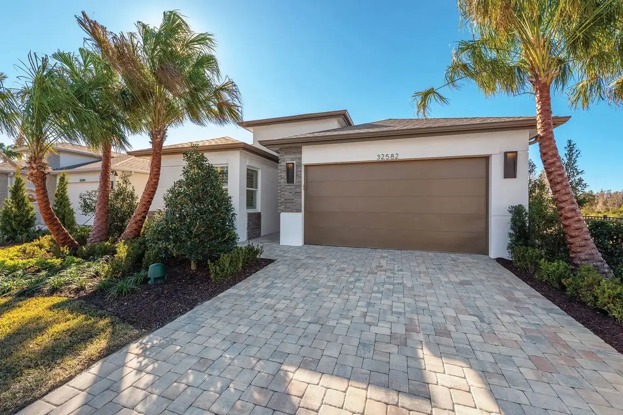 Front exterior of a new home in Valencia Ridge, Wesley Chapel, FL, highlighting curb appeal (Image 2).