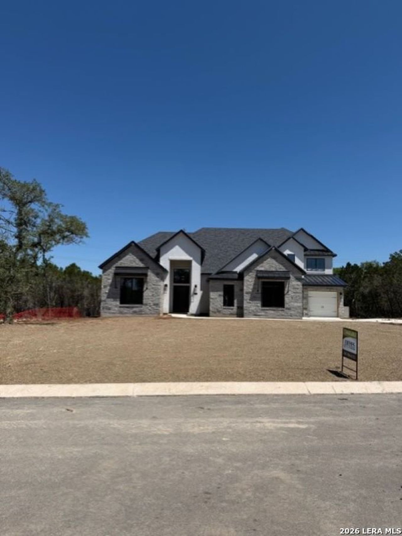 Front exterior of a new home in Enchanted Bluff, San Antonio, TX, highlighting curb appeal (Image 2).