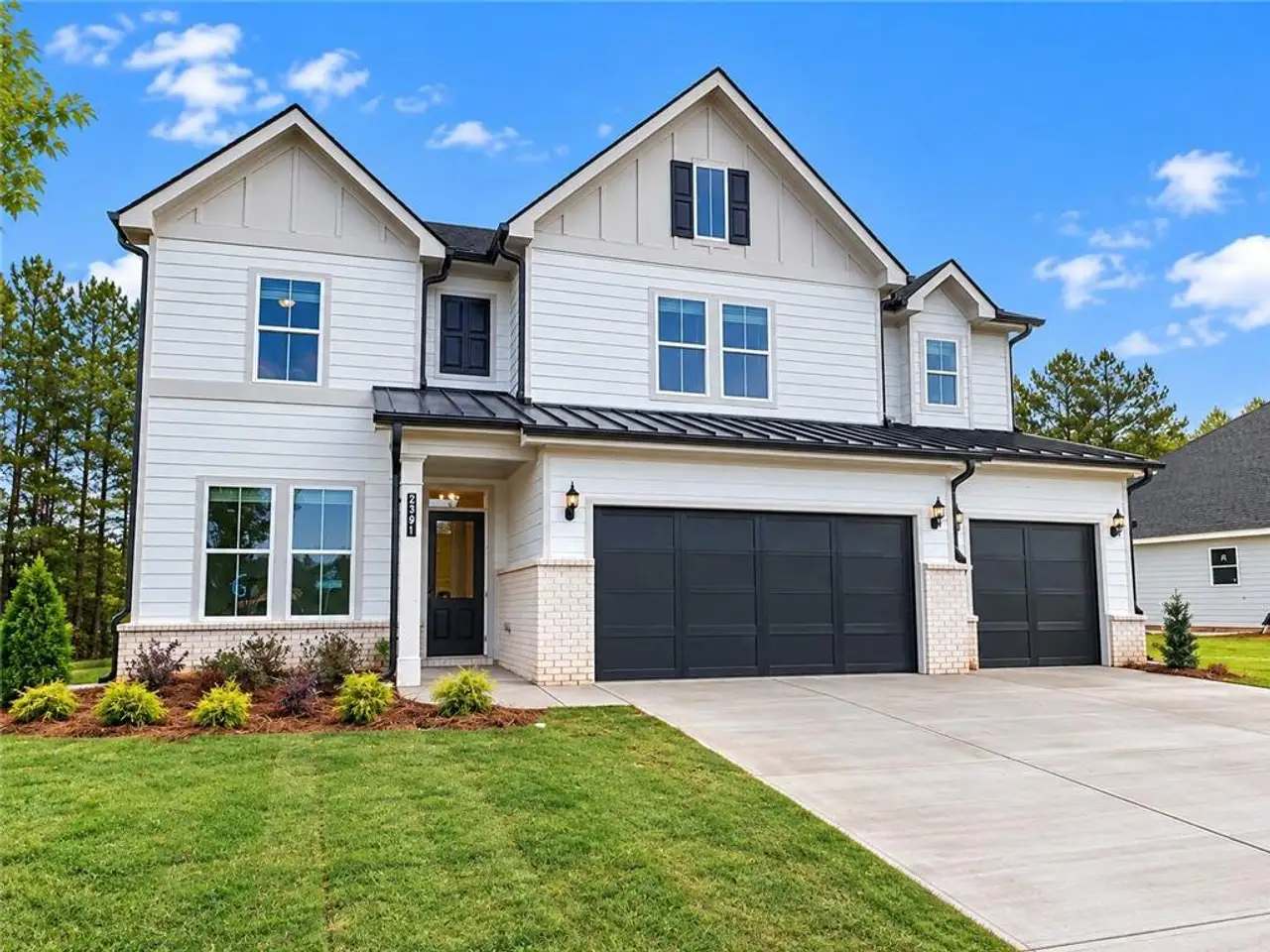 Front exterior of a new home in Bay Creek Overlook, Loganville, GA, highlighting curb appeal (Image 2). Front exterior of a new home in Bay Creek Overlook, Loganville, GA, highlighting curb appeal (Image 2).