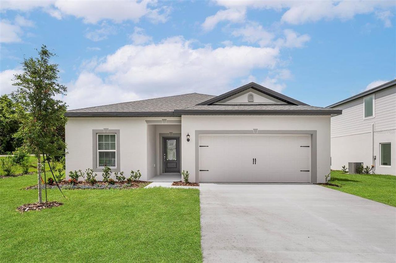 Front exterior of a new home in Tula Parc, Astatula, FL, highlighting curb appeal (Image 2).