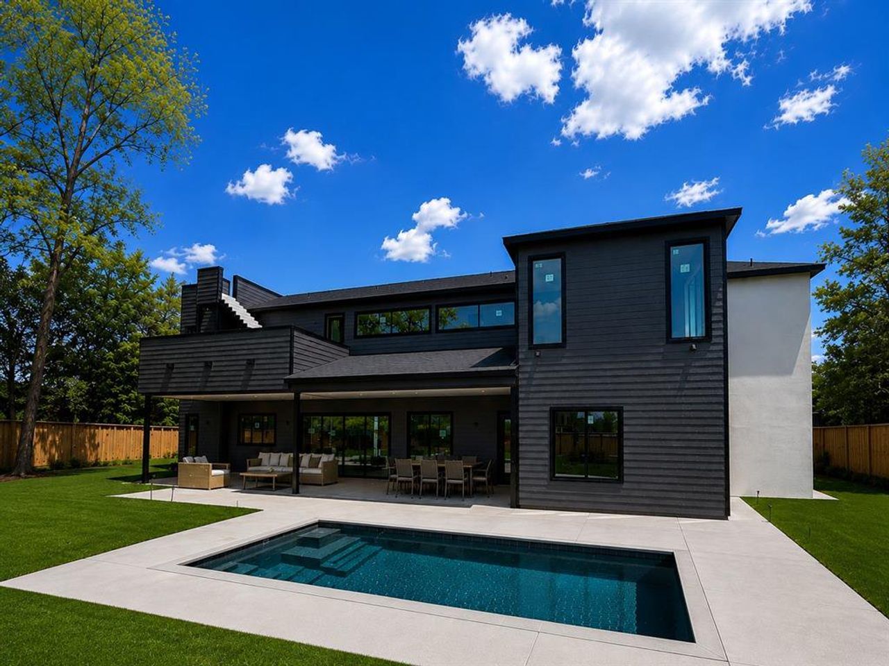 Contemporary exterior with dark horizontal siding and a flat roofline