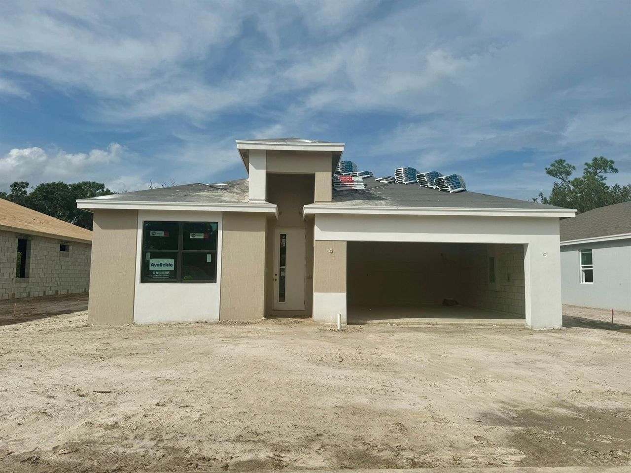 Front exterior of a new home in Twin Oaks, Stuart, FL, highlighting curb appeal (Image 2).