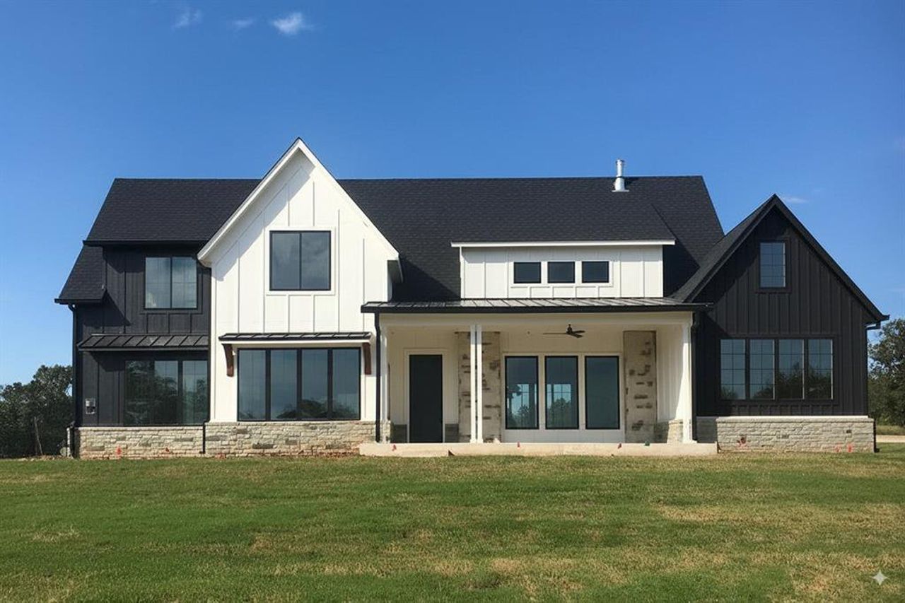 Back of house featuring a standing seam roof, a metal roof, board and batten siding, and a shingled roof Back of house featuring a standing seam roof, a metal roof, board and batten siding, and a shingled roof