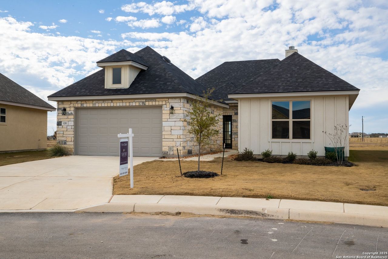 Front exterior of a new home in Boehme Ranch, Castroville, TX, highlighting curb appeal (Image 2). Front exterior of a new home in Boehme Ranch, Castroville, TX, highlighting curb appeal (Image 2).