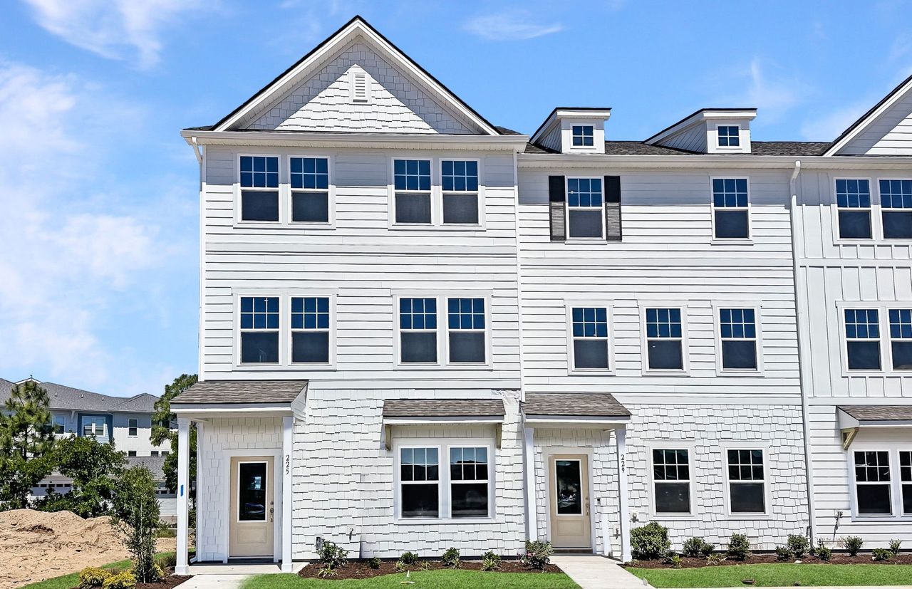 Front exterior of a new home in Lakeside Townes at Riverlights, Wilmington, NC, highlighting curb appeal (Image 2).