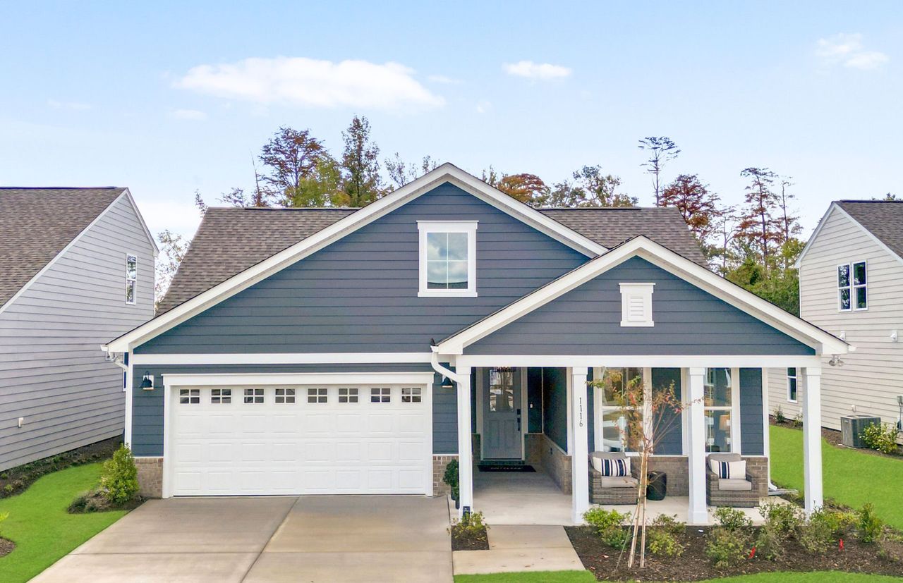 Front exterior of a new home in The Haven at Riverlights, Wilmington, NC, highlighting curb appeal (Image 2). Front exterior of a new home in The Haven at Riverlights, Wilmington, NC, highlighting curb appeal (Image 2).