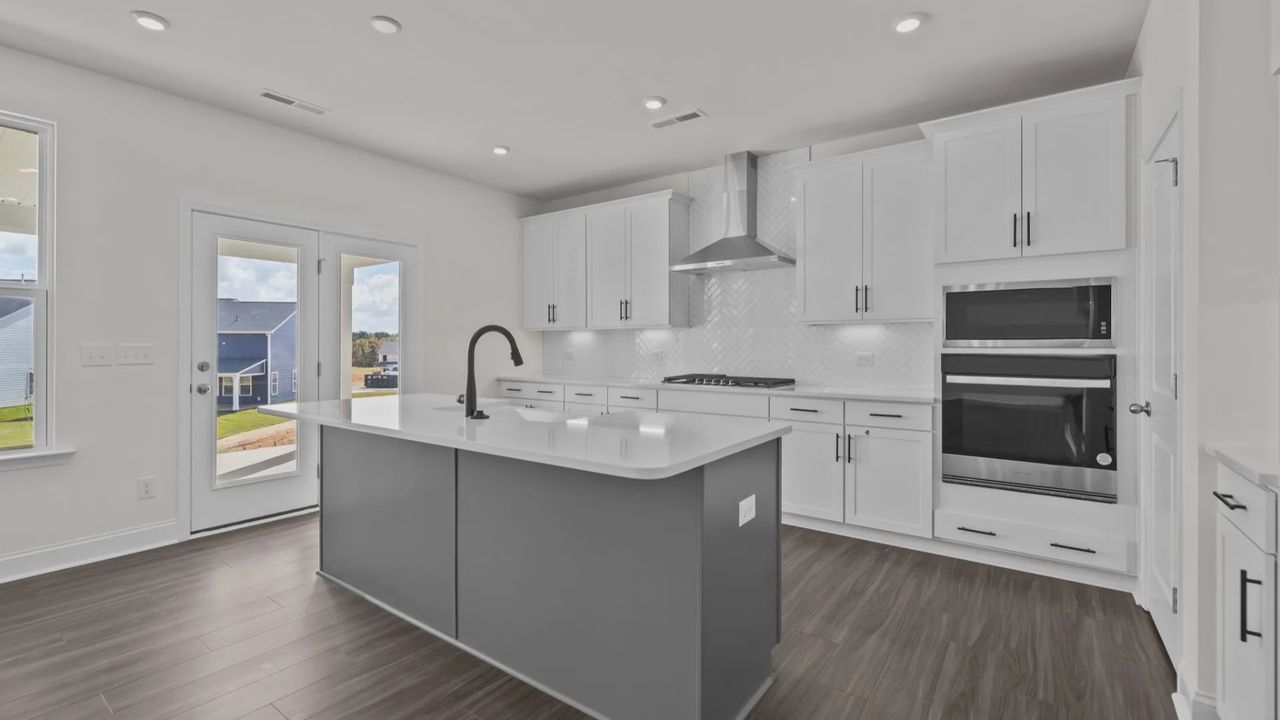 Gourmet Kitchen option with wall oven/microwave and vented hood, in the Burton Design by DRB Homes in Mooresville, NC