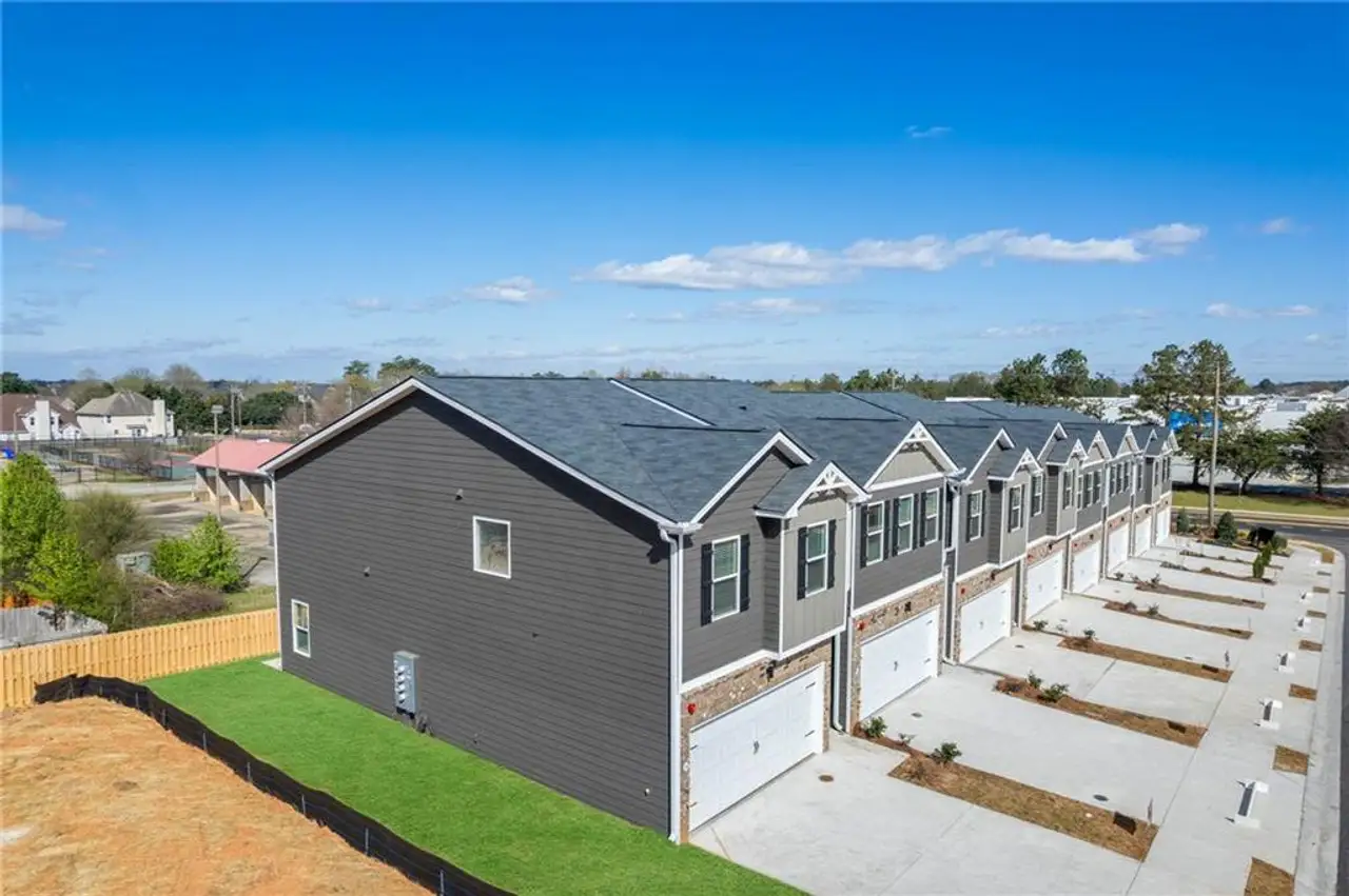 Exterior details and patio area of a home in The Enclave Townhomes, Hampton (Image 2). Exterior details and patio area of a home in The Enclave Townhomes, Hampton (Image 2).