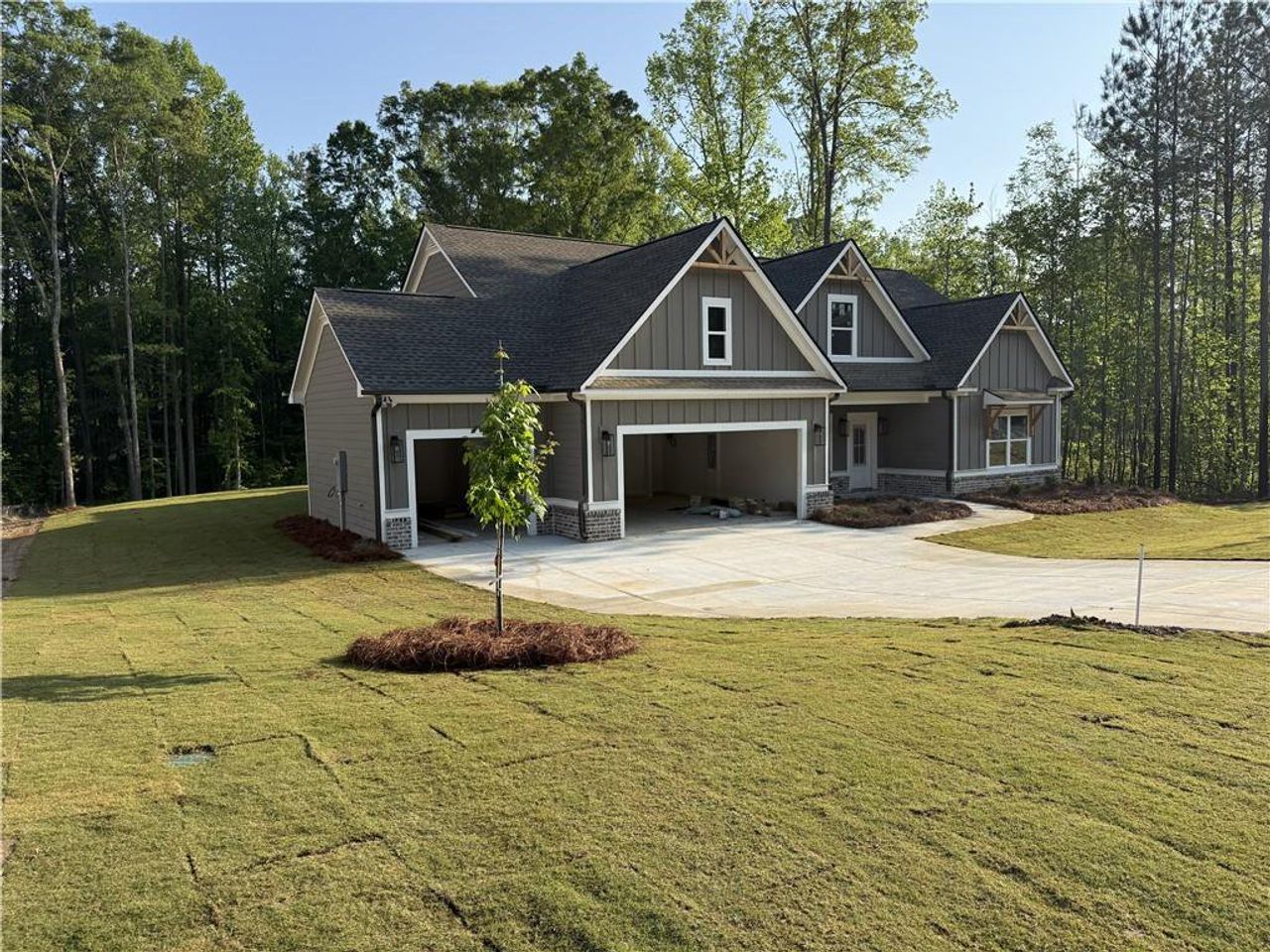 Front exterior of a new home in Woodland Hills, Loganville, GA, highlighting curb appeal (Image 2). Front exterior of a new home in Woodland Hills, Loganville, GA, highlighting curb appeal (Image 2).