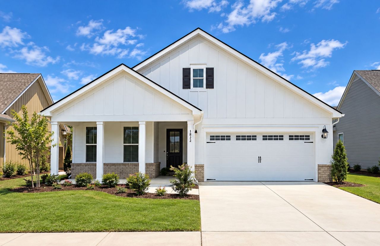 Front exterior of a new home in Del Webb Wilmington at Mallory Creek, Leland, NC, highlighting curb appeal (Image 2). Front exterior of a new home in Del Webb Wilmington at Mallory Creek, Leland, NC, highlighting curb appeal (Image 2).