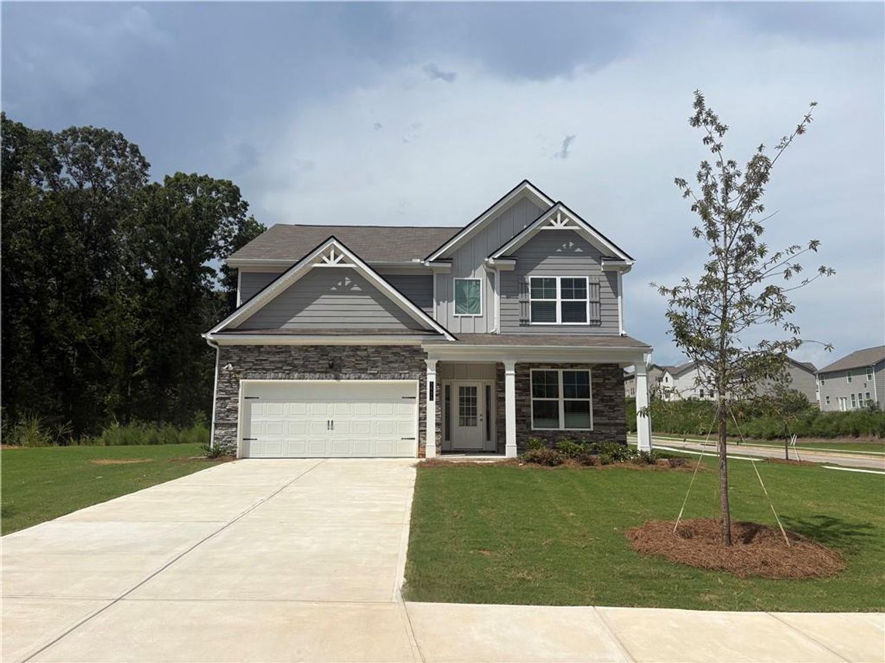 Front exterior of a new home in Highland Park, Stonecrest, GA, highlighting curb appeal (Image 2).