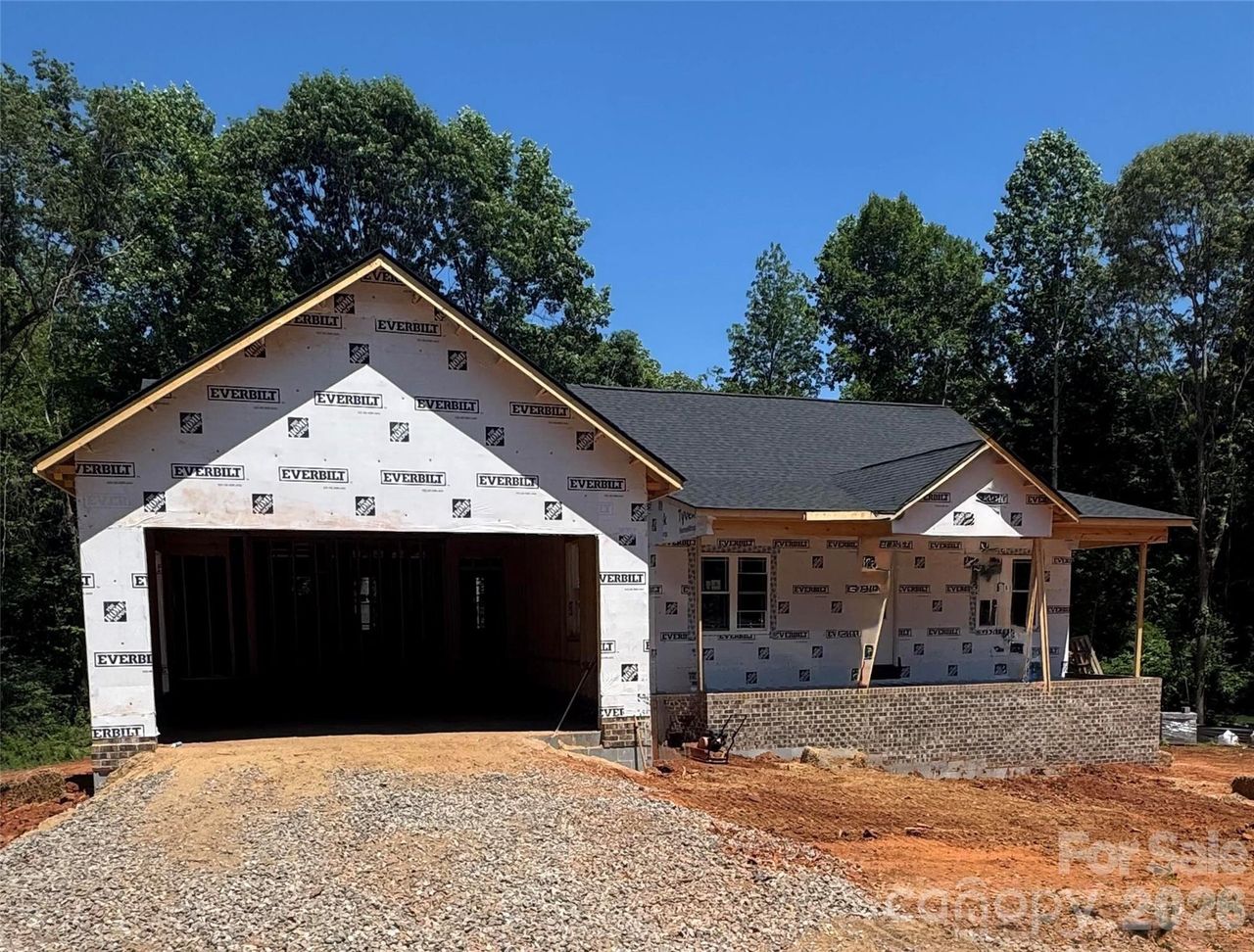 Front view of home. Covered front patio with wood ceiling