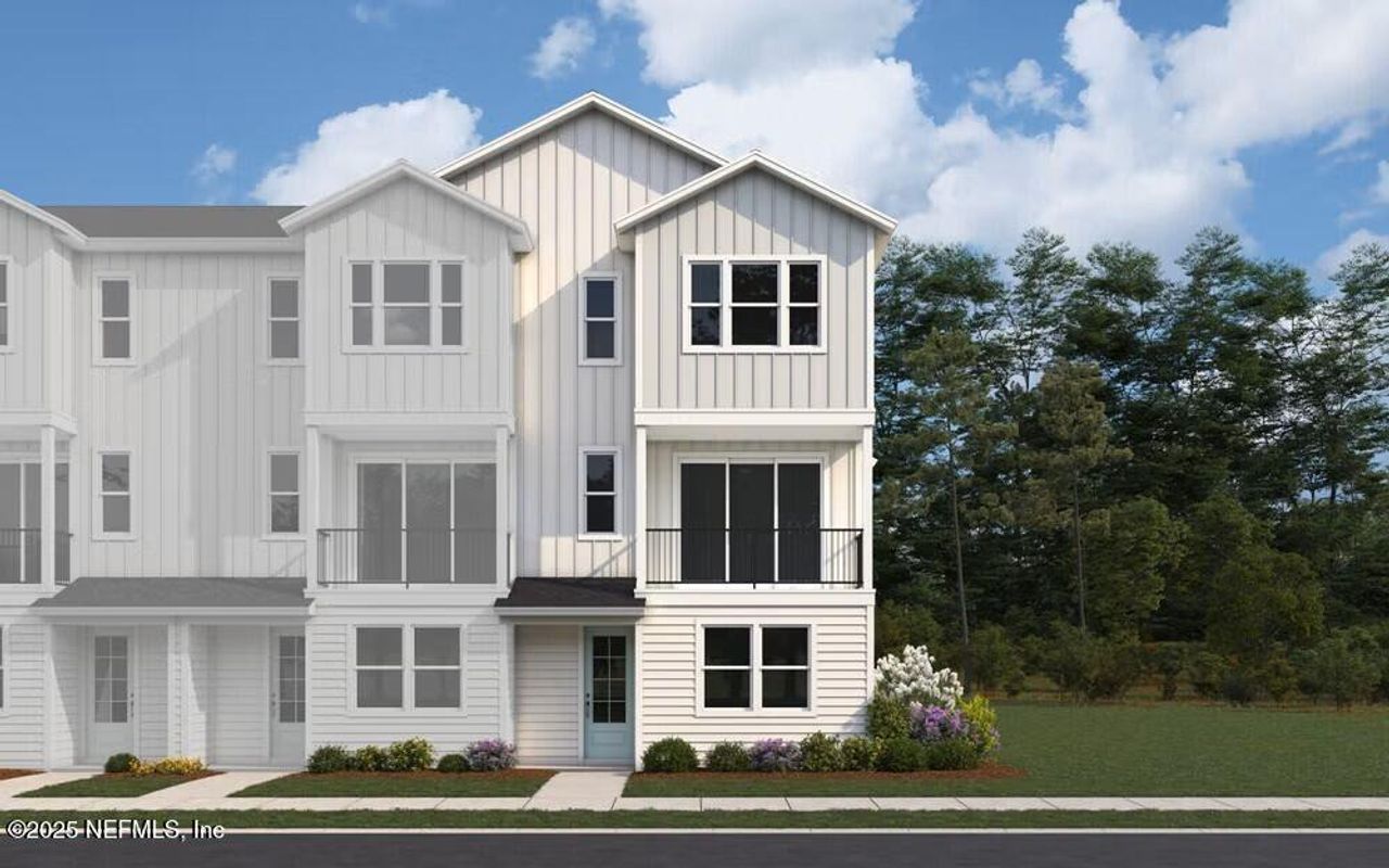 Front exterior of a new home in North Beach Townhomes, Jacksonville Beach, FL, highlighting curb appeal (Image 2).