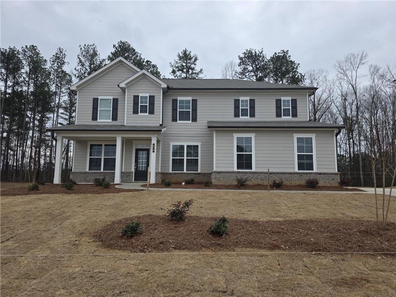 Front exterior of a new home in Oakhurst Manor, McDonough, GA, highlighting curb appeal (Image 2). Front exterior of a new home in Oakhurst Manor, McDonough, GA, highlighting curb appeal (Image 2).