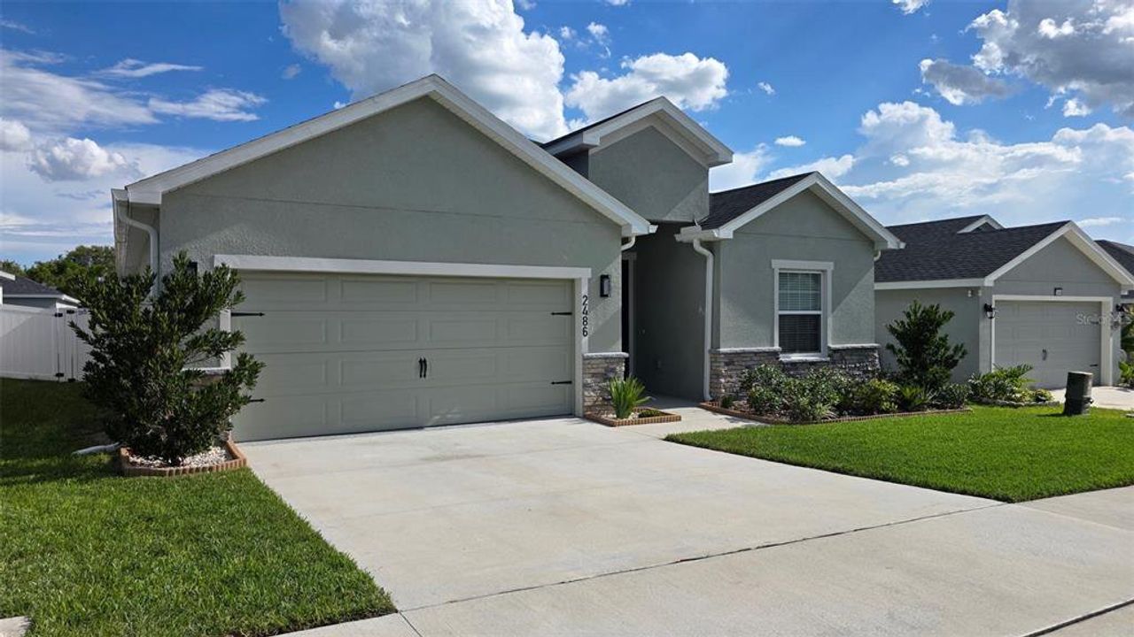 Front exterior of a new home in Geneva Landings, Davenport, FL, highlighting curb appeal (Image 2). Front exterior of a new home in Geneva Landings, Davenport, FL, highlighting curb appeal (Image 2).