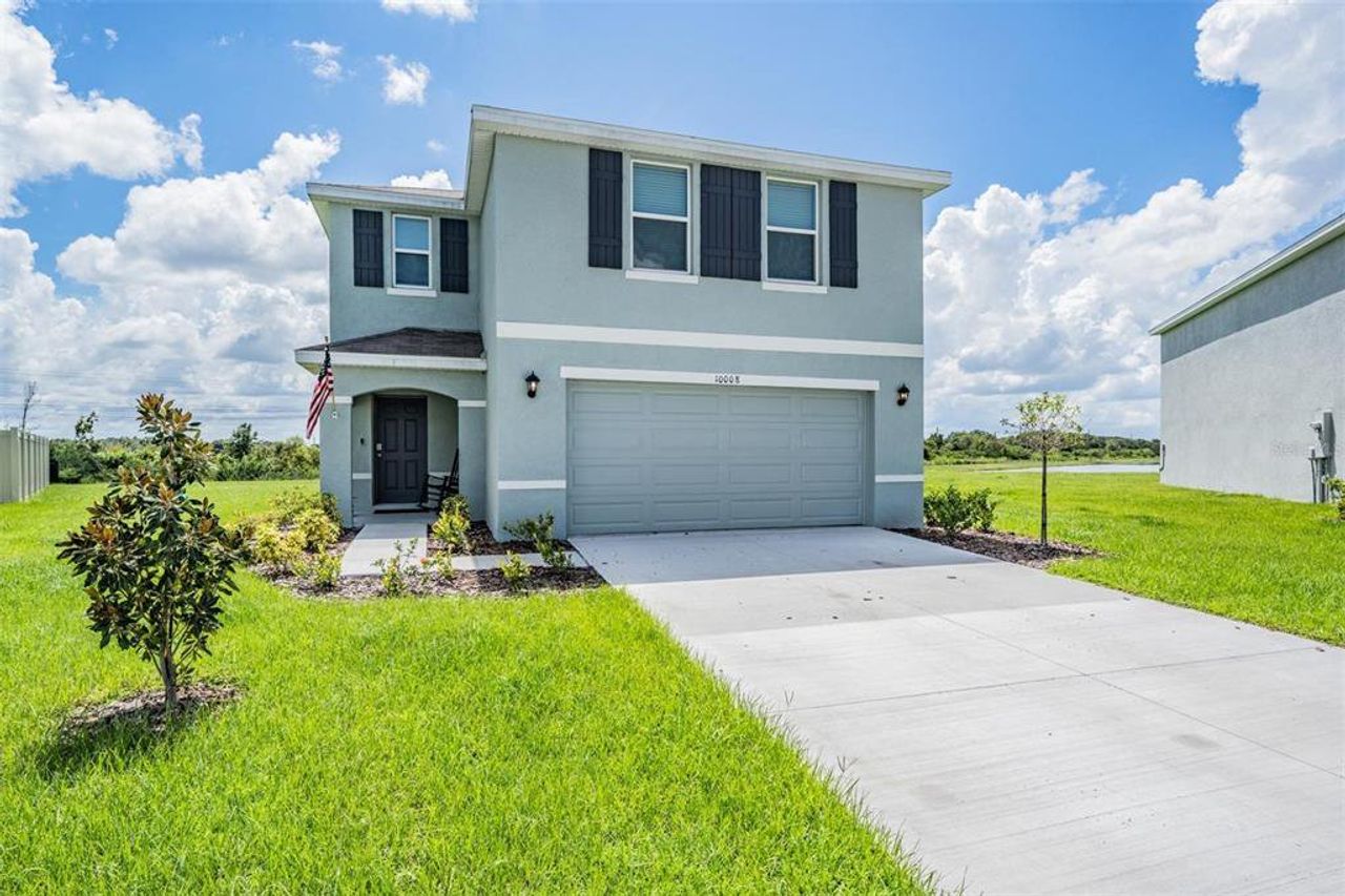 Front exterior of a new home in Bella Lago, Parrish, FL, highlighting curb appeal (Image 2).