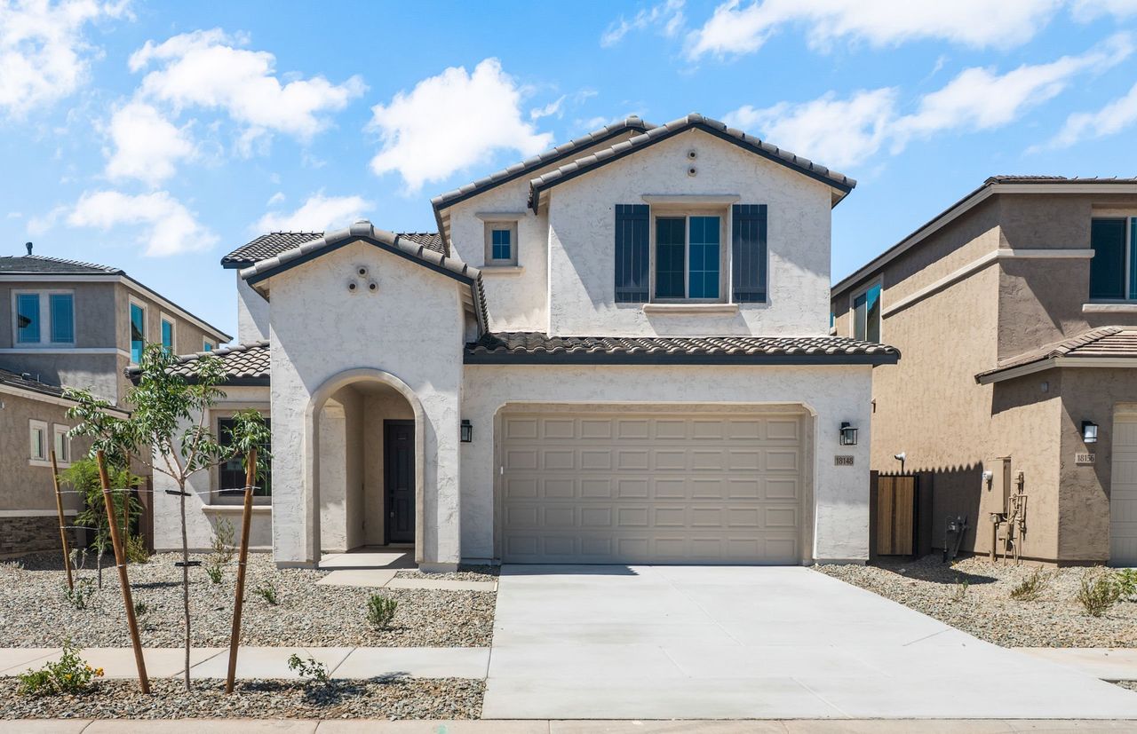 Front exterior of a new home in Legado West, Queen Creek, AZ, highlighting curb appeal (Image 2). Front exterior of a new home in Legado West, Queen Creek, AZ, highlighting curb appeal (Image 2).