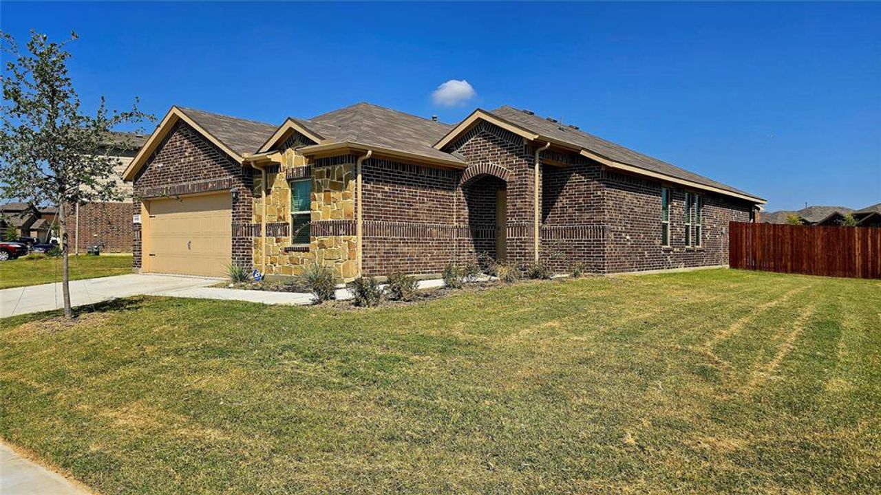 Ranch-style home with brick siding, concrete driveway, and an attached garage Ranch-style home with brick siding, concrete driveway, and an attached garage