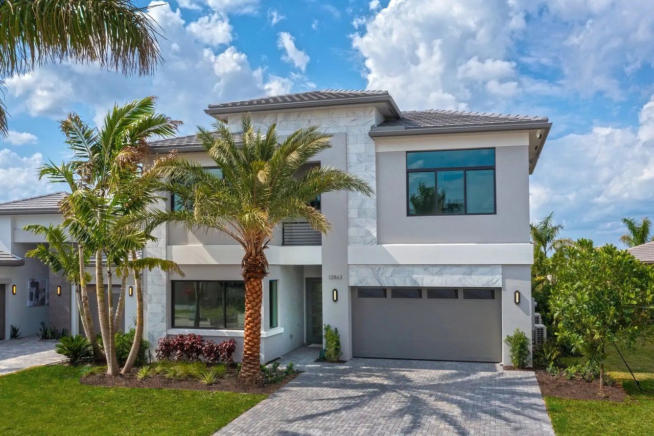 Front exterior of a new home in Apex at Avenir, Palm Beach Gardens, FL, highlighting curb appeal (Image 2). Front exterior of a new home in Apex at Avenir, Palm Beach Gardens, FL, highlighting curb appeal (Image 2).