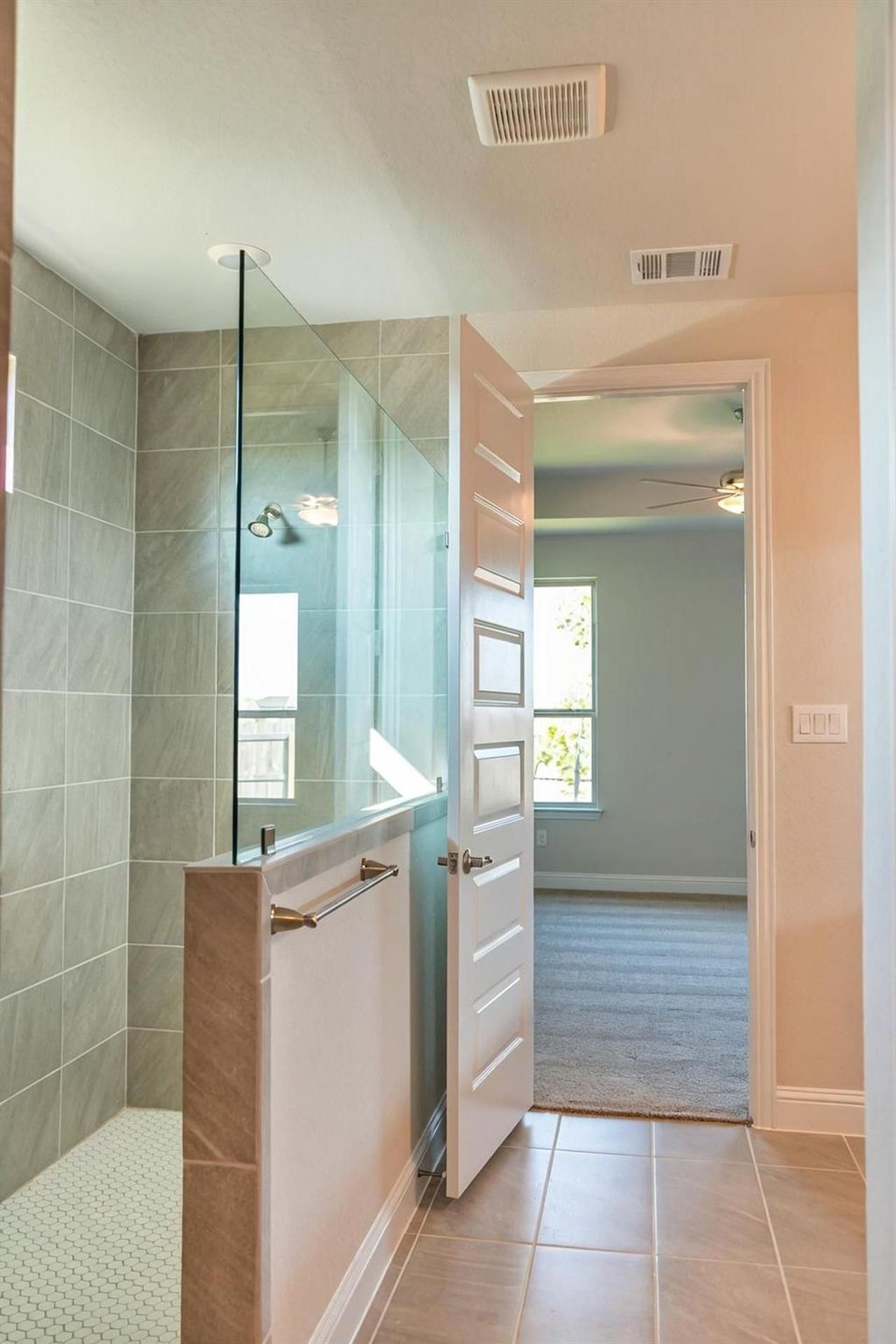 Full bath with a walk in shower, light tile patterned floors, and light carpet