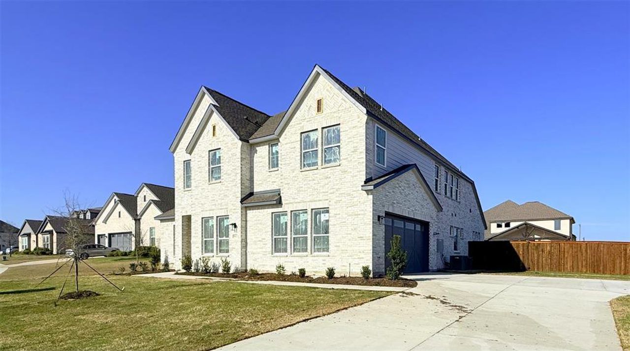 Front exterior of a new home in Polo Ridge, Mesquite, TX, highlighting curb appeal (Image 2).