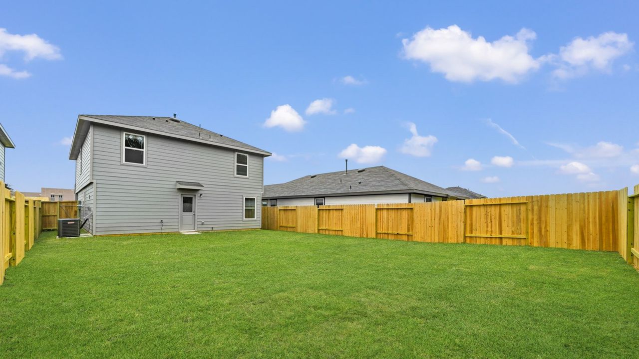Exterior details and patio area of a home in The Canopies, Splendora (Image 2).