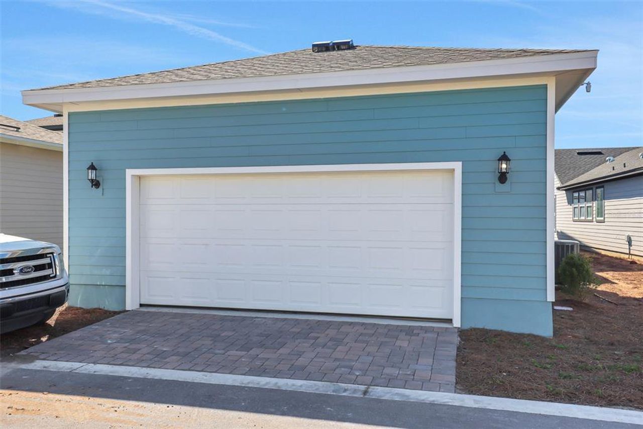 Front exterior of a new home in Weslyn Park at Sunbridge (Craft Homes), St. Cloud, FL, highlighting curb appeal (Image 2).