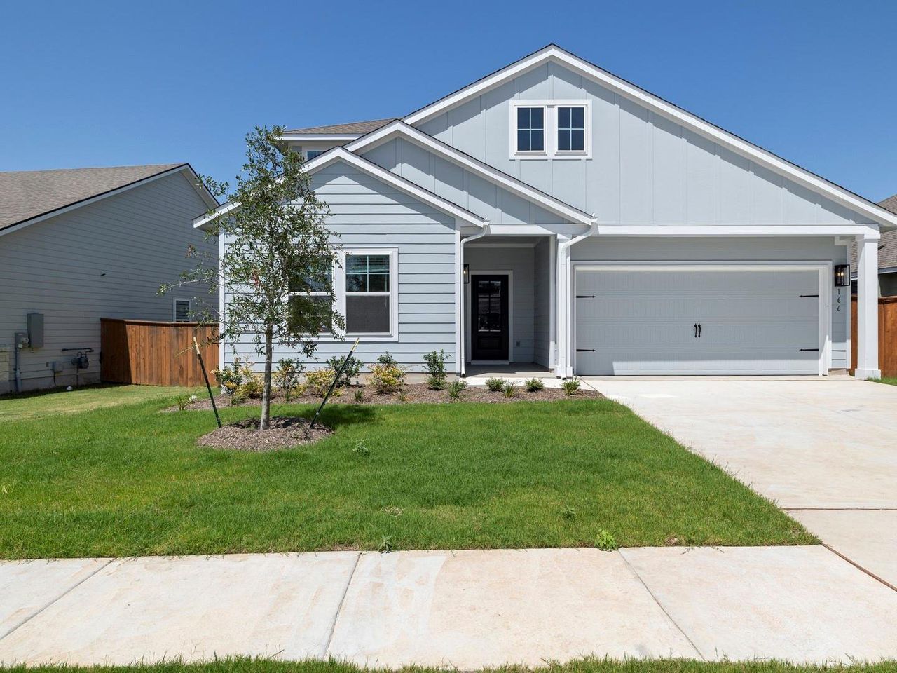 Front exterior of a new home in Orchard Ridge, Liberty Hill, TX, highlighting curb appeal (Image 2).