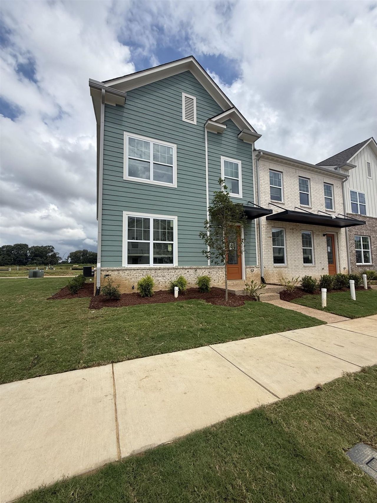 Two-story residence featuring light blue siding with white trim accents Two-story residence featuring light blue siding with white trim accents