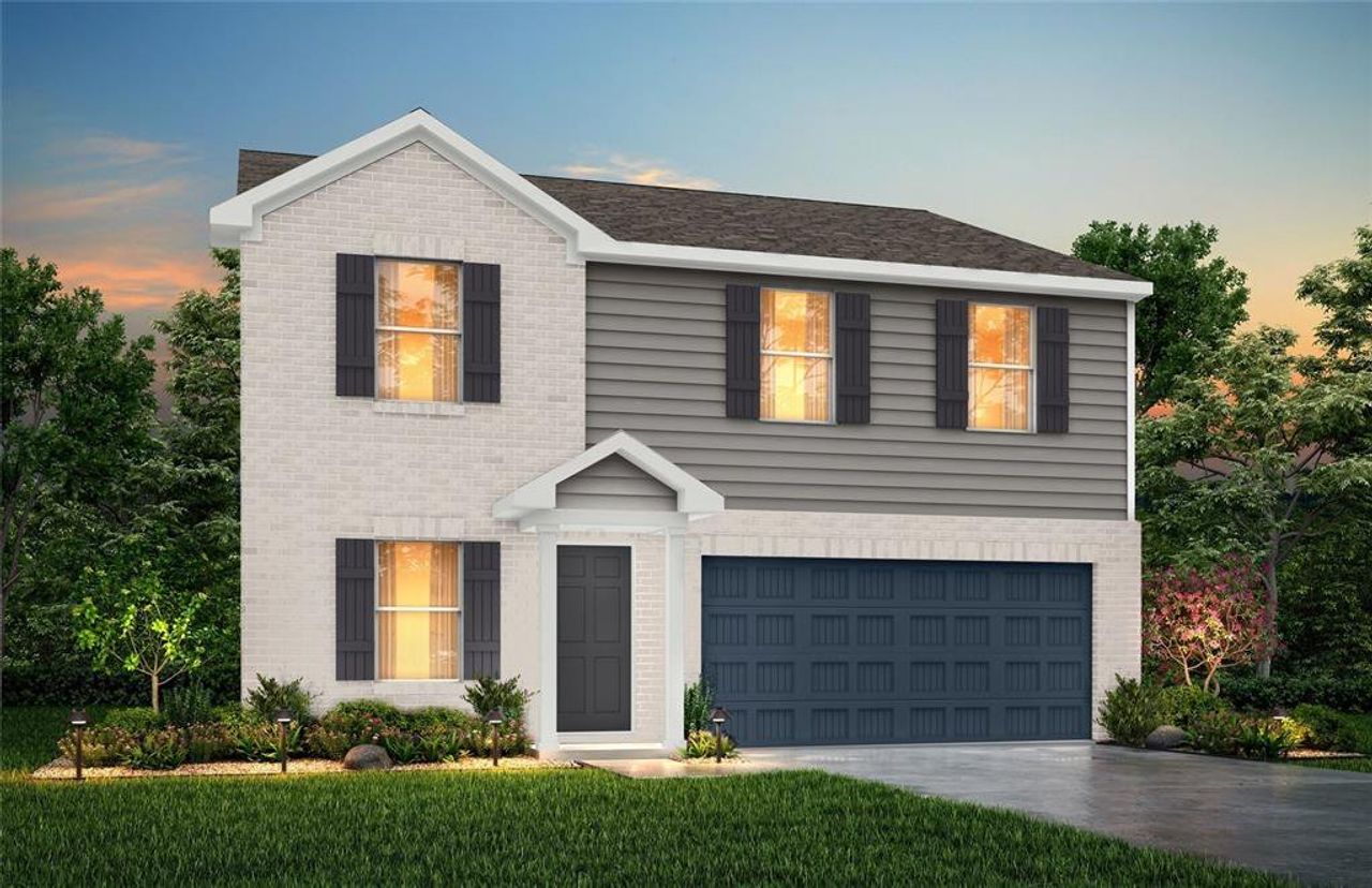 View of front of property featuring driveway, brick siding, and a garage