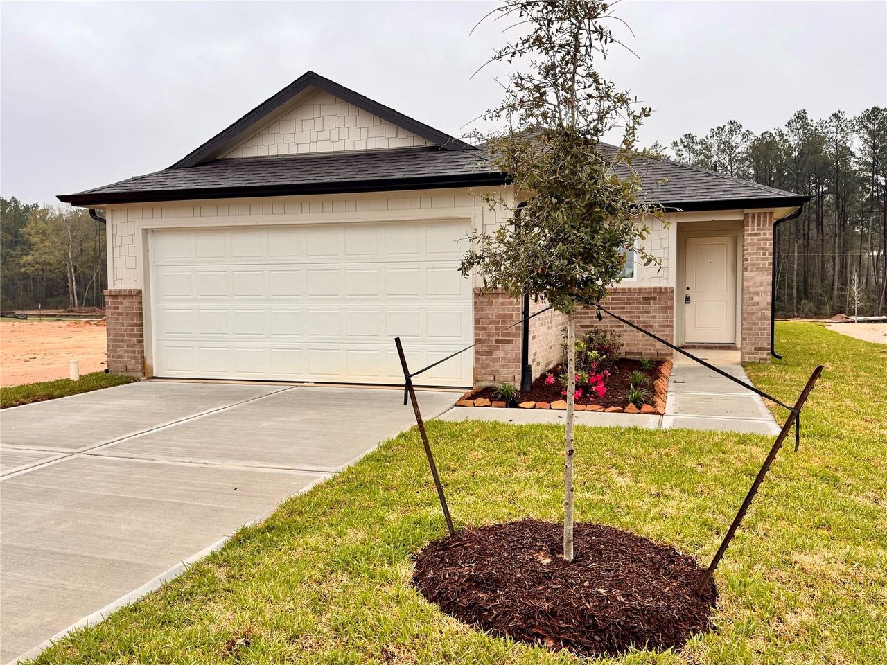 Front exterior of a new home in The Enclave at Spring Branch, Conroe, TX, highlighting curb appeal (Image 2).