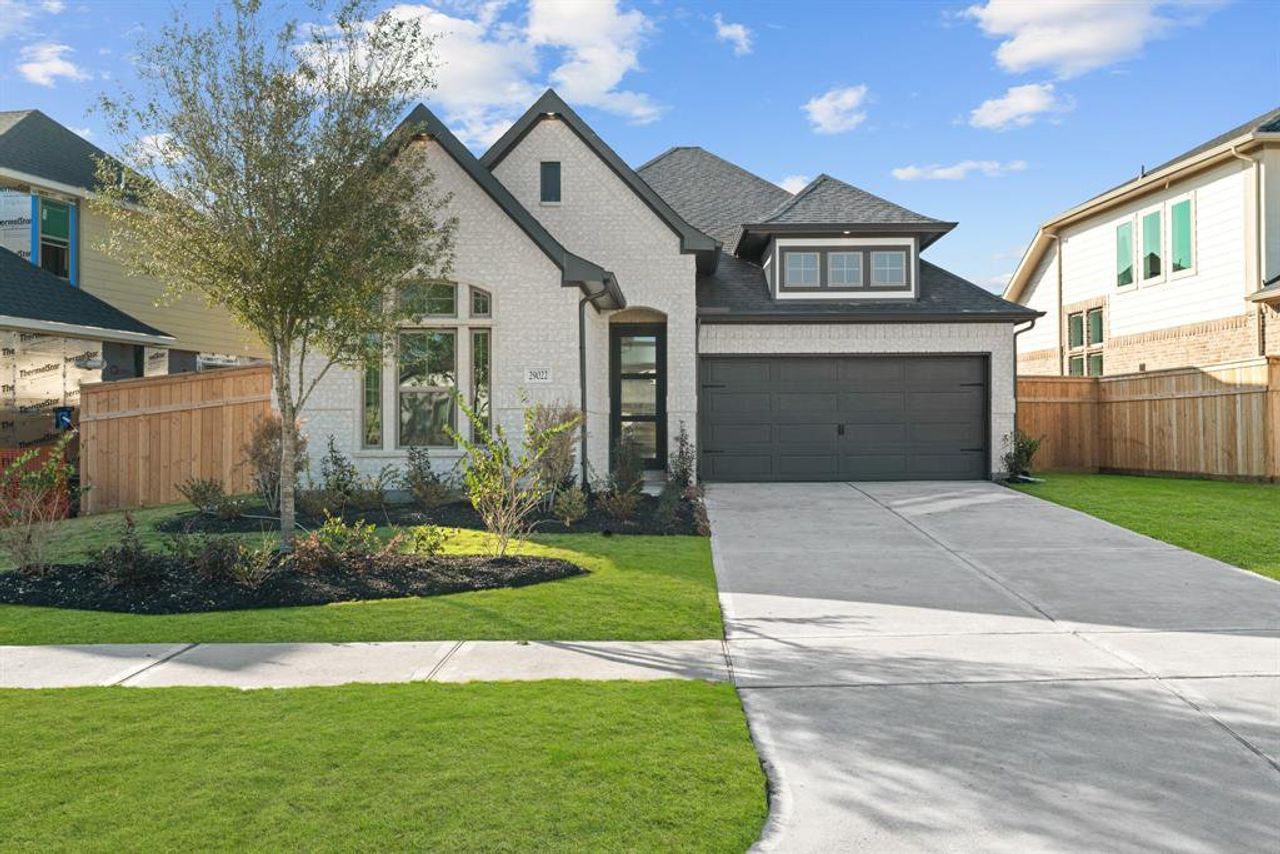 Front exterior of a new home in Cross Creek Ranch 45' 70', Fulshear, TX, highlighting curb appeal (Image 2). Front exterior of a new home in Cross Creek Ranch 45' 70', Fulshear, TX, highlighting curb appeal (Image 2).