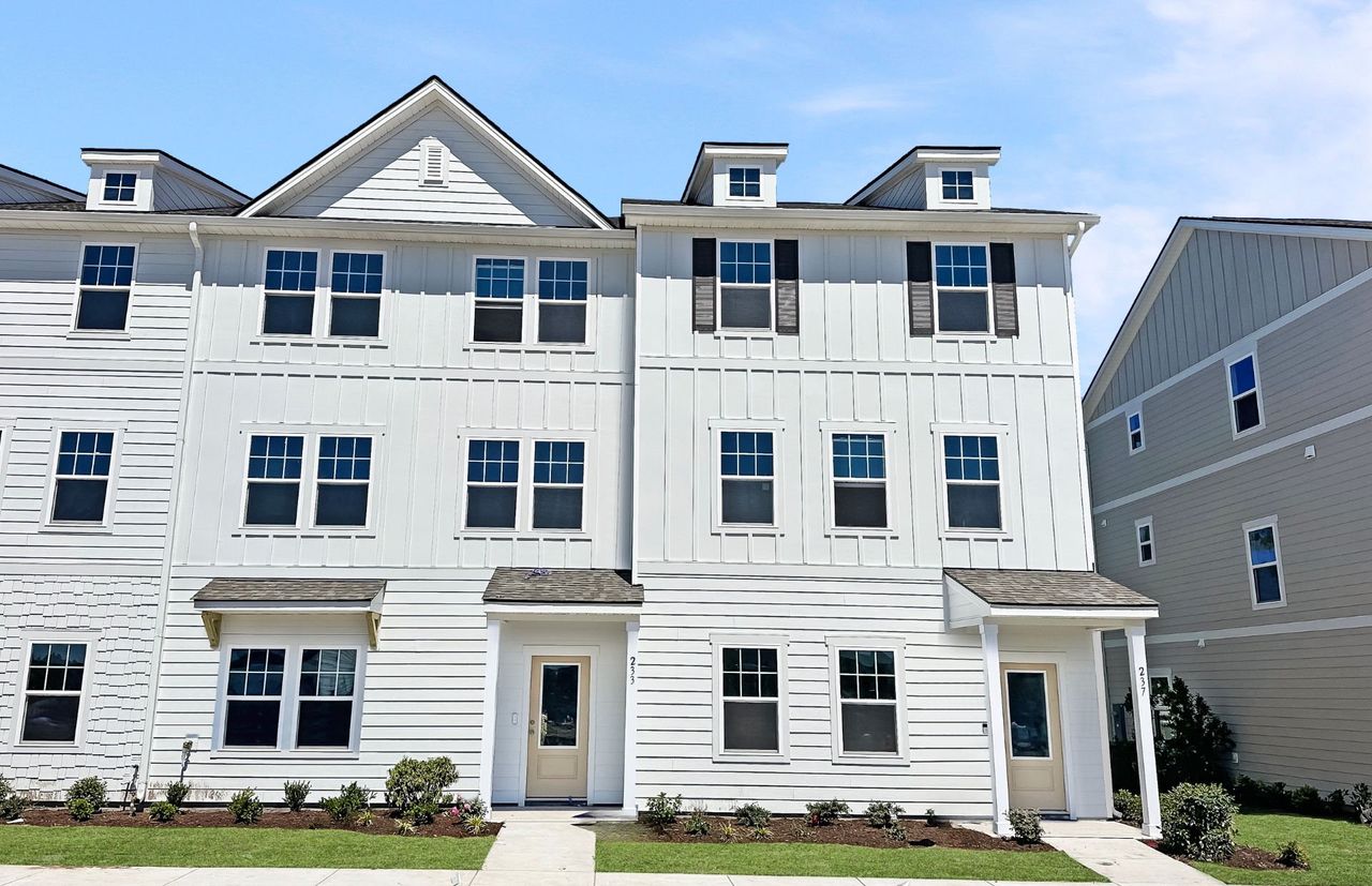 Front exterior of a new home in Lakeside Townes at Riverlights, Wilmington, NC, highlighting curb appeal (Image 2).