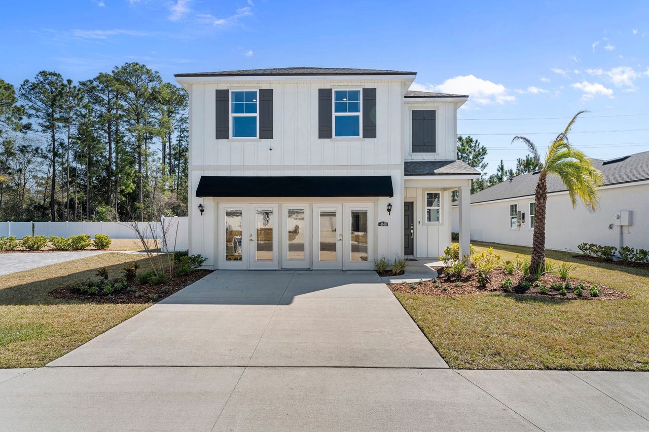 A white house with a driveway.